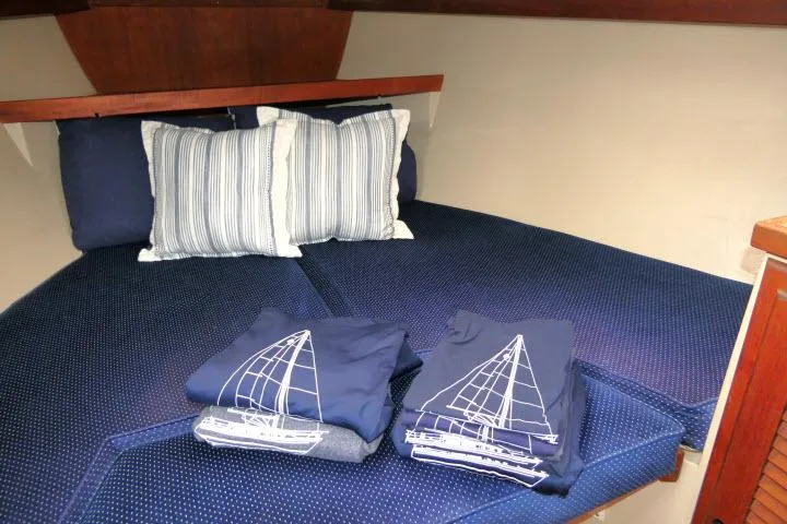 Slide: The Image of Cozy cabin interior of 1988 Catalina 34 sailboat with nautical-themed bedding. - 28