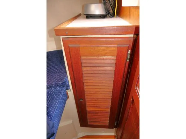 Slide: The Image of Wooden cabinet in 1988 Catalina 34 sailboat interior with blue upholstery. - 32