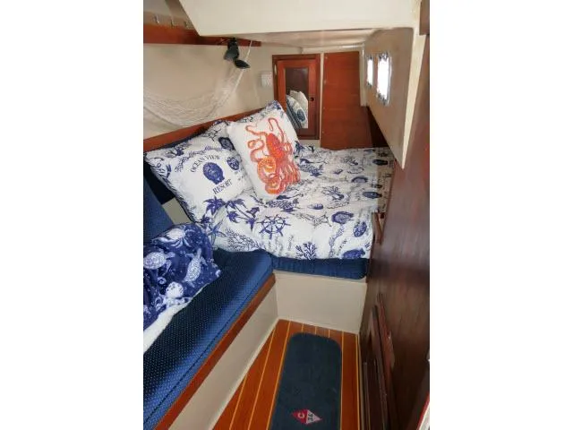 Slide: The Image of Cozy cabin interior of 1988 Catalina 34 sailboat with nautical-themed bedding. - 33