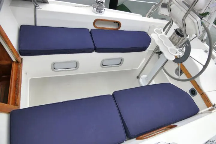Slide: The Image of 1988 Catalina 34 sailboat cockpit with blue cushions and steering wheel. - 40