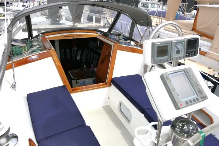 Slide: The Image of Cockpit of a 1988 Catalina 34 sailboat with navigation instruments and blue seating. - 45