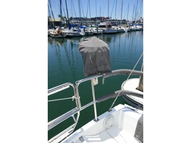 Slide: The Image of 1988 Catalina 34 sailboat docked in marina, covered equipment on deck. - 49