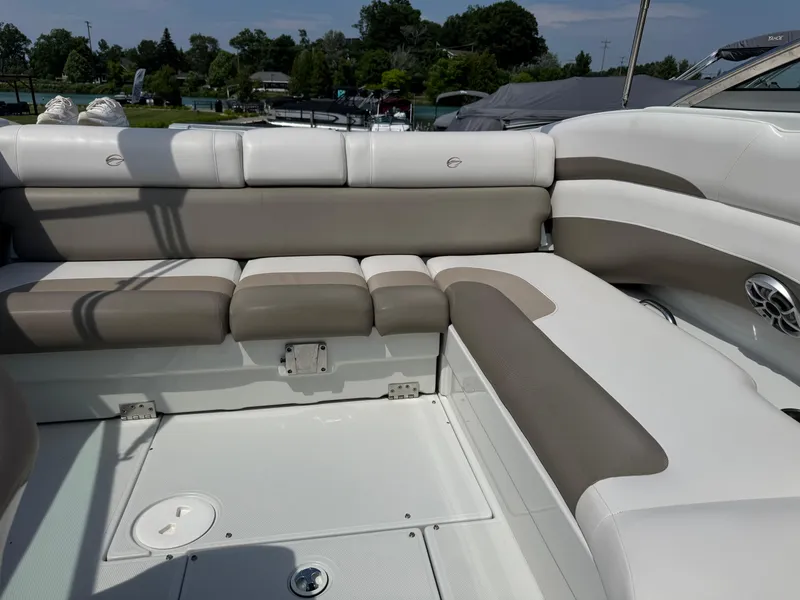 Slide: The Image of 2014 Crownline 235 SS boat interior with beige and white seating. - 12