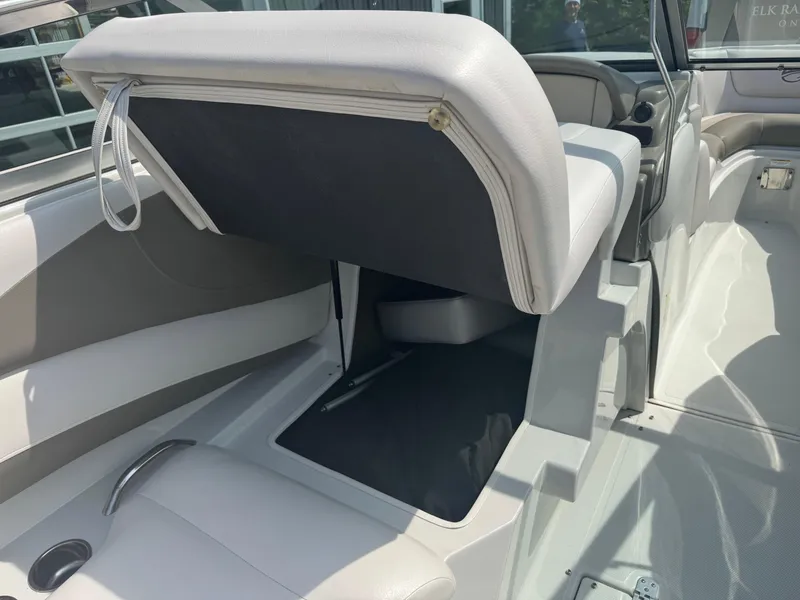 Slide: The Image of 2014 Crownline 235 SS boat interior with open storage compartment. - 16