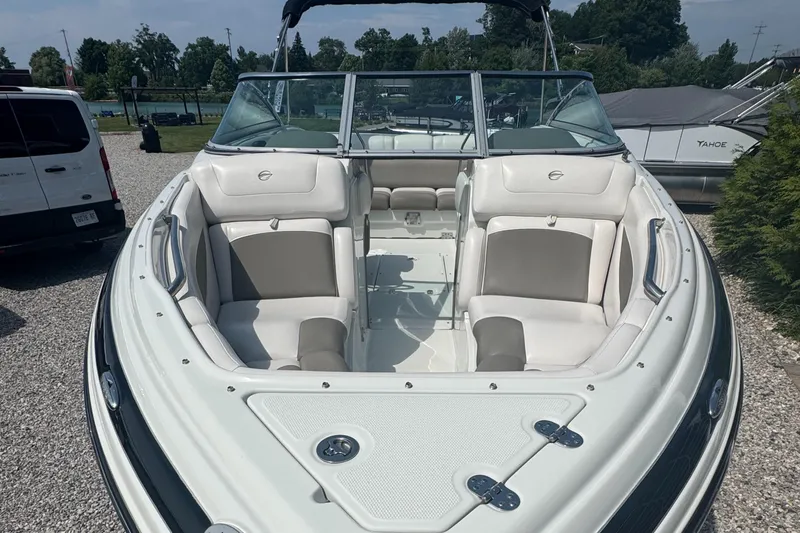 Slide: The Image of 2014 Crownline 235 SS boat with spacious seating, parked outdoors on gravel. - 8