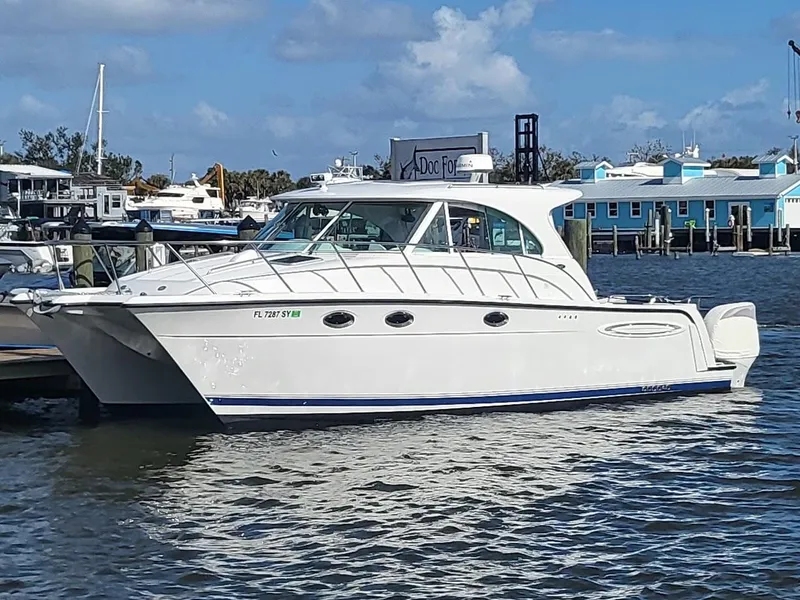 The Image of 2005 Glacier Bay 3480 Ocean Runner boat docked at marina under blue sky. - 0
