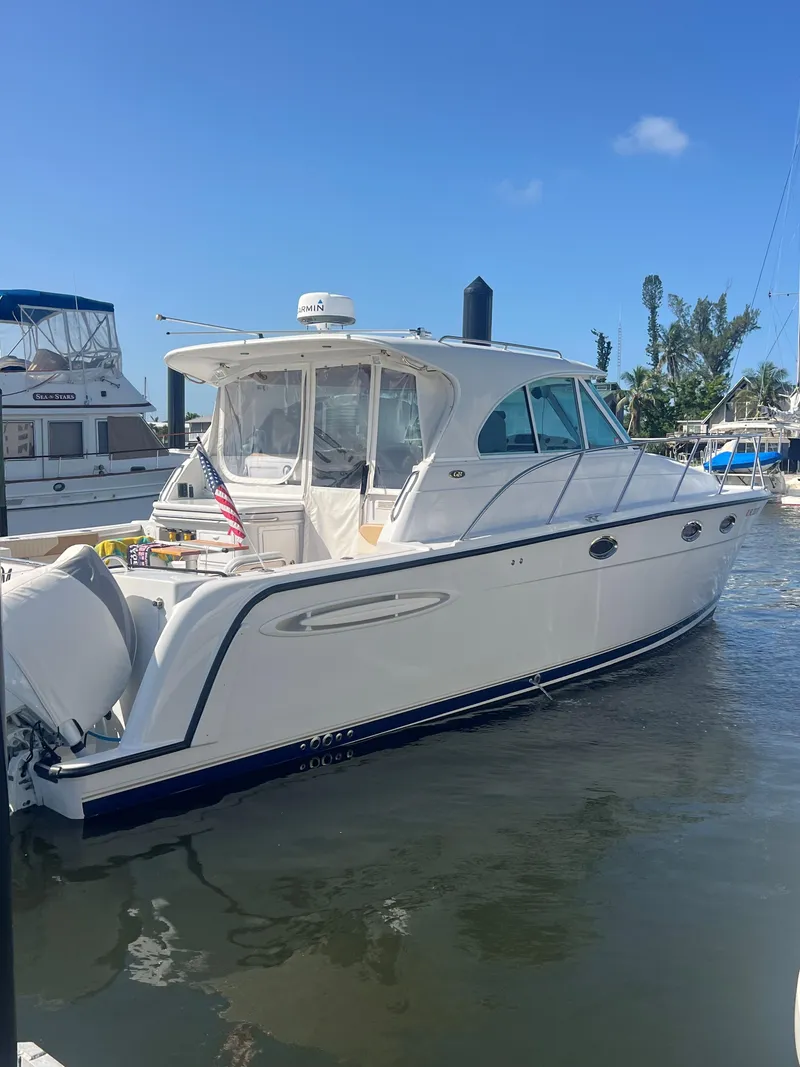 Slide: The Image of 2005 Glacier Bay 3480 Ocean Runner boat docked at marina under clear blue sky. - 14