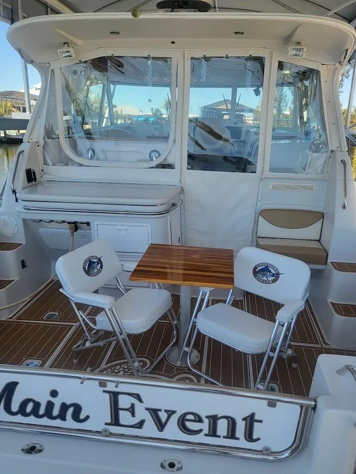 Slide: The Image of 2005 Glacier Bay 3480 Ocean Runner boat with seating area and table on deck. - 4