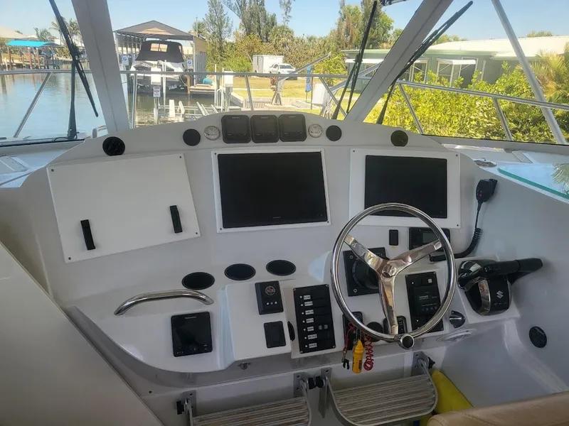 Slide: The Image of Helm of 2005 Glacier Bay 3480 Ocean Runner with dual screens and steering wheel. - 8