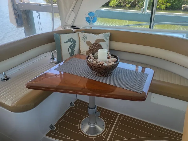 Slide: The Image of Interior of 2005 Glacier Bay 3480 Ocean Runner with cozy seating and decorative table. - 9