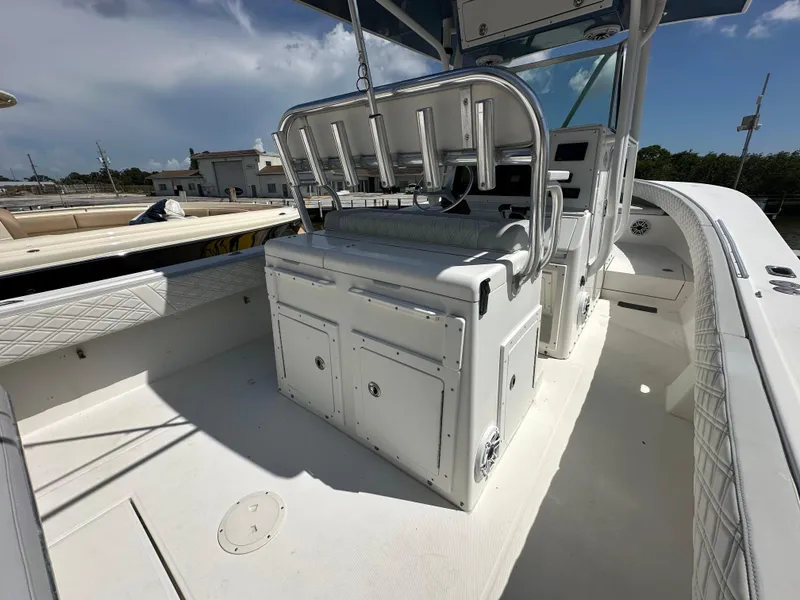 Slide: The Image of 2002 Regulator 32 Forward Seating boat interior with helm and seating area. - 19