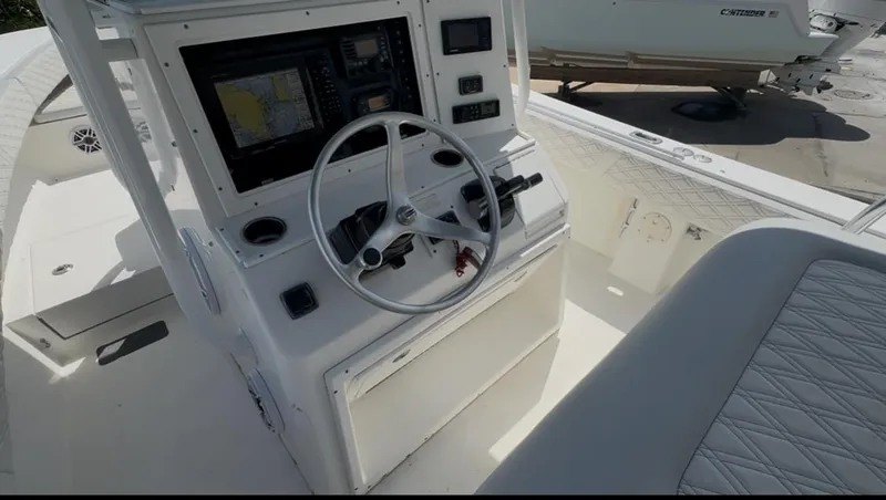 Slide: The Image of 2002 Regulator 32 Forward Seating boat cockpit with steering wheel and navigation equipment. - 28