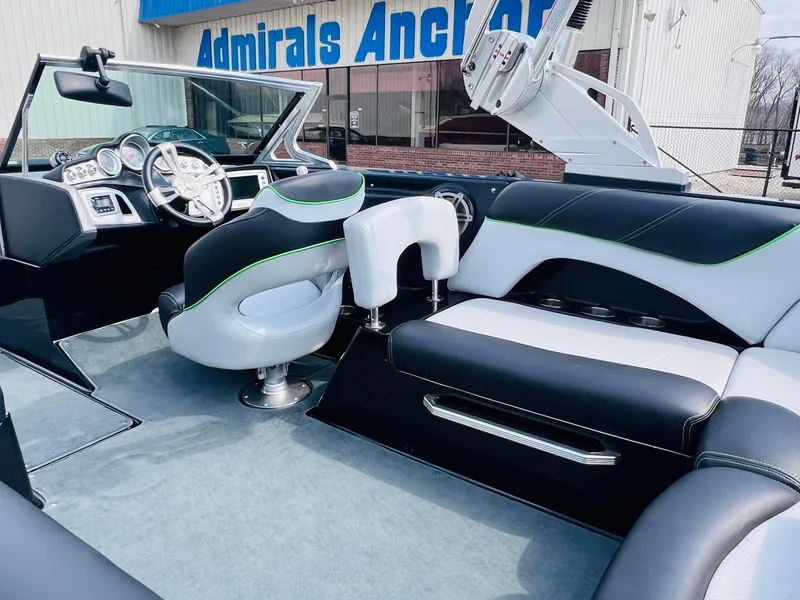 Slide: The Image of 2015 MasterCraft X25 boat interior with sleek seating and modern dashboard. - 10