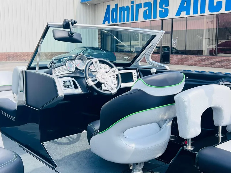 Slide: The Image of 2015 MasterCraft X25 boat interior with modern dashboard and stylish seating. - 11