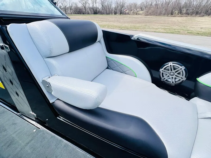 Slide: The Image of 2015 MasterCraft X25 boat interior with white and black seating, speaker detail. - 15