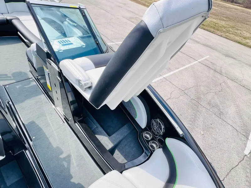 Slide: The Image of 2015 MasterCraft X25 boat interior with white seating and cup holders. - 16