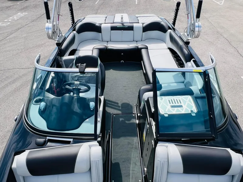 Slide: The Image of 2015 MasterCraft X25 boat interior with sleek seating and modern dashboard design. - 18
