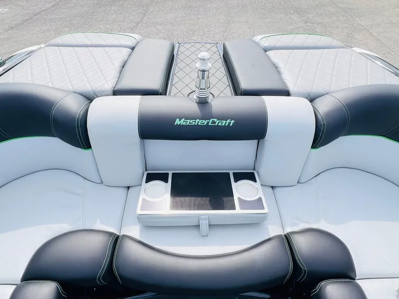 Slide: The Image of 2015 MasterCraft X25 boat interior with luxurious seating and cup holders. - 23