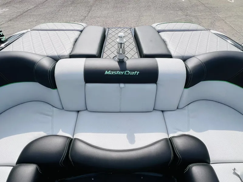 Slide: The Image of 2015 MasterCraft X25 boat interior with black and white cushioned seating. - 24