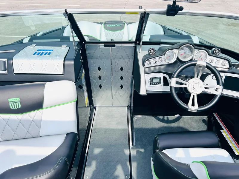 Slide: The Image of 2015 MasterCraft X25 boat interior with sleek dashboard and modern seating design. - 26
