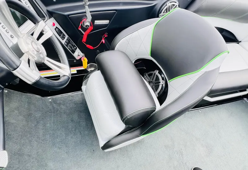 Slide: The Image of 2015 MasterCraft X25 boat interior with steering wheel and stylish seating. - 28