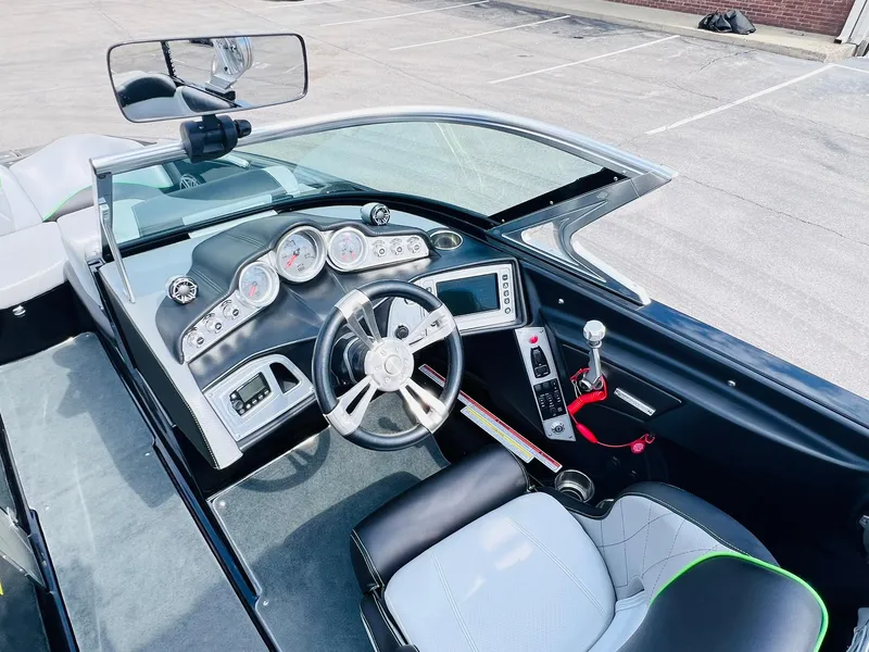 Slide: The Image of 2015 MasterCraft X25 boat cockpit with modern controls and steering wheel. - 30