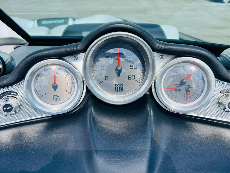 Slide: The Image of Dashboard of a 2015 MasterCraft X25 boat with speedometer and gauges. - 33