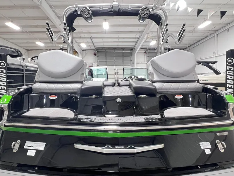 Slide: The Image of 2015 MasterCraft X25 boat interior with sleek design and modern features in a showroom. - 38