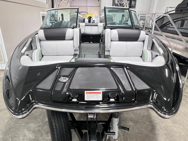 Slide: The Image of 2015 MasterCraft X25 boat interior with black and white seating, displayed indoors. - 41