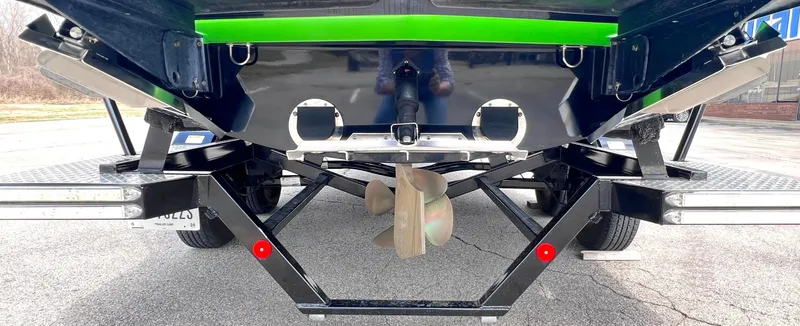 Slide: The Image of 2015 MasterCraft X25 boat underside with propeller and trailer, featuring green accents. - 42