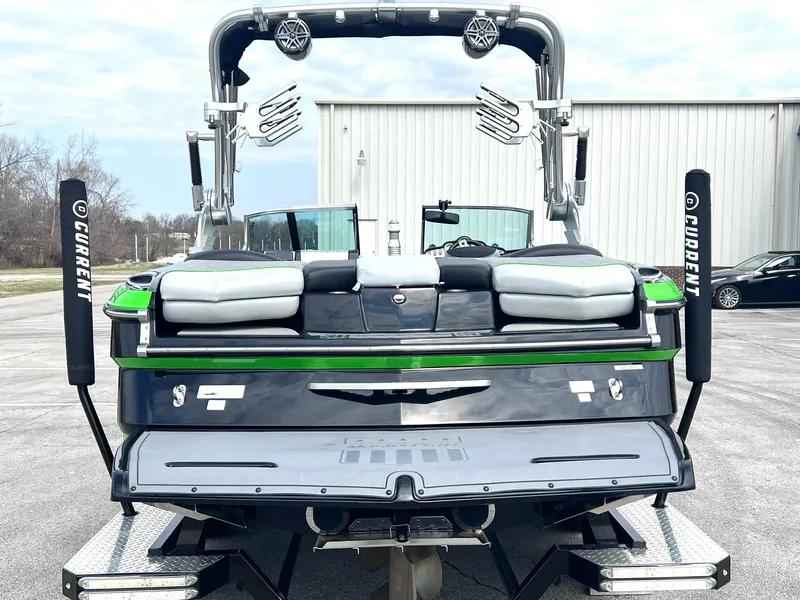 Slide: The Image of 2015 MasterCraft X25 boat, rear view, parked outdoors with wakeboard tower and speakers. - 6