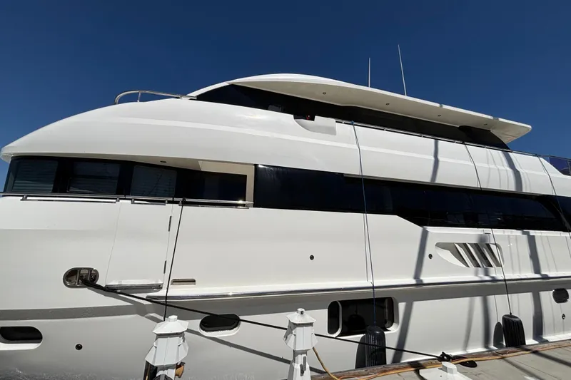 Slide: The Image of Luxury Norseman 80 yacht docked, 2010 model, sleek white design under clear blue sky. - 114