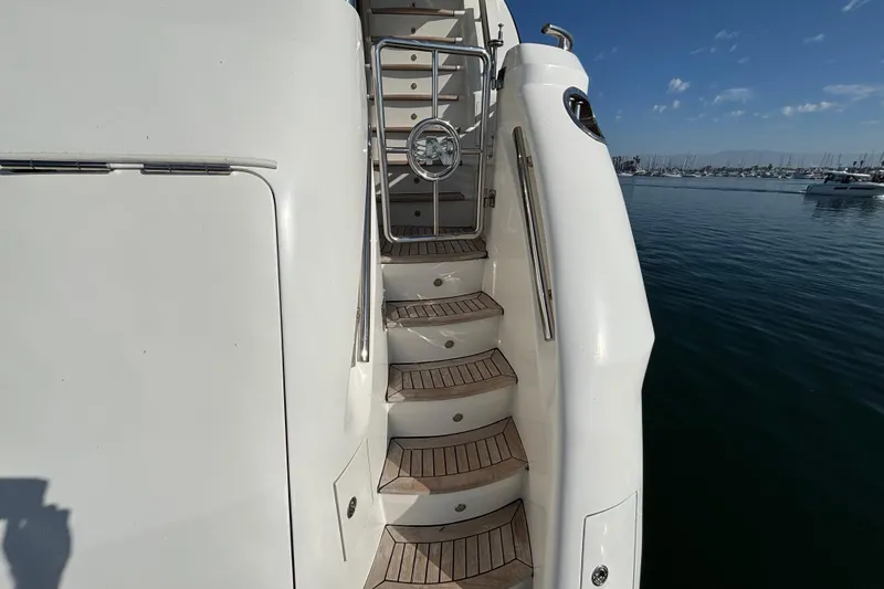 Slide: The Image of Staircase on 2010 Norseman 80 yacht with wooden steps, docked by calm waters. - 121