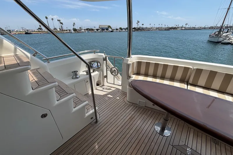Slide: The Image of Luxurious 2010 Norseman 80 yacht deck with seating, table, and ocean view. - 128