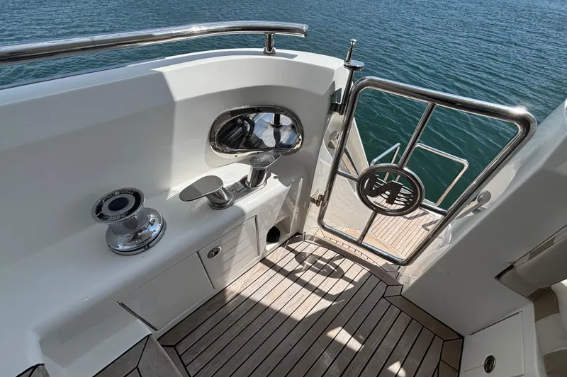 Slide: The Image of Norseman 80 yacht deck, 2010 model, featuring stainless steel gate and winch by the water. - 129