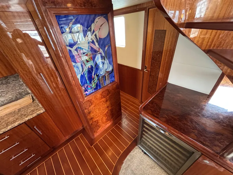 Slide: The Image of Luxurious Norseman 80 yacht interior with wood paneling and vibrant abstract artwork, 2010 model. - 13