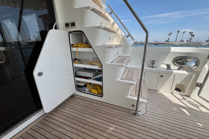 Slide: The Image of Norseman 80 yacht deck with open storage, stairs, and ocean view, 2010 model. - 135