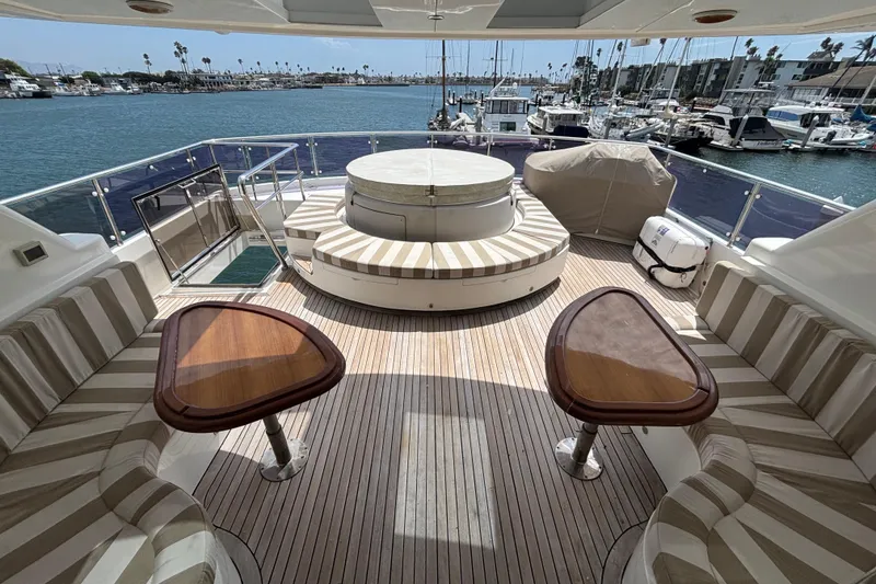 Slide: The Image of Luxurious 2010 Norseman 80 yacht deck with seating, tables, and marina view. - 138