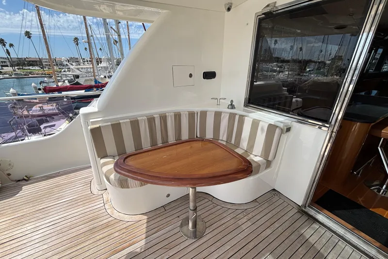 Slide: The Image of Cozy seating area on 2010 Norseman 80 yacht with striped cushions and wooden table. - 141