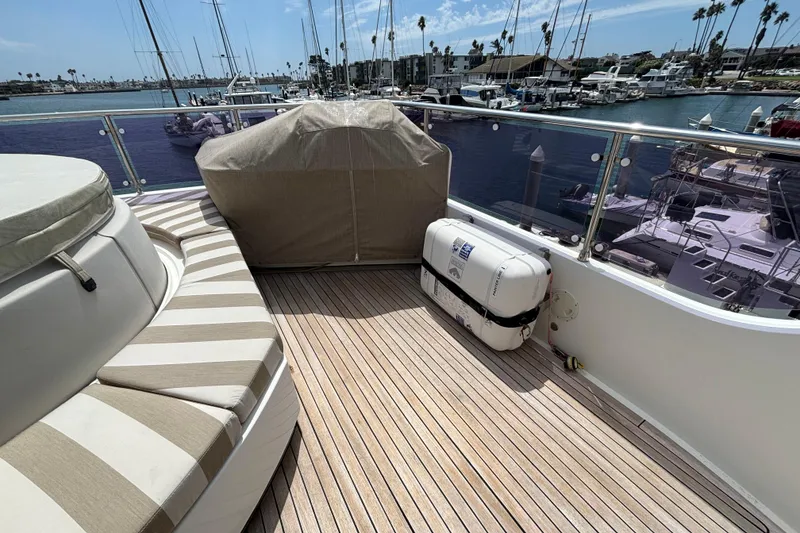 Slide: The Image of Deck of 2010 Norseman 80 yacht with striped seating and marina view. - 144