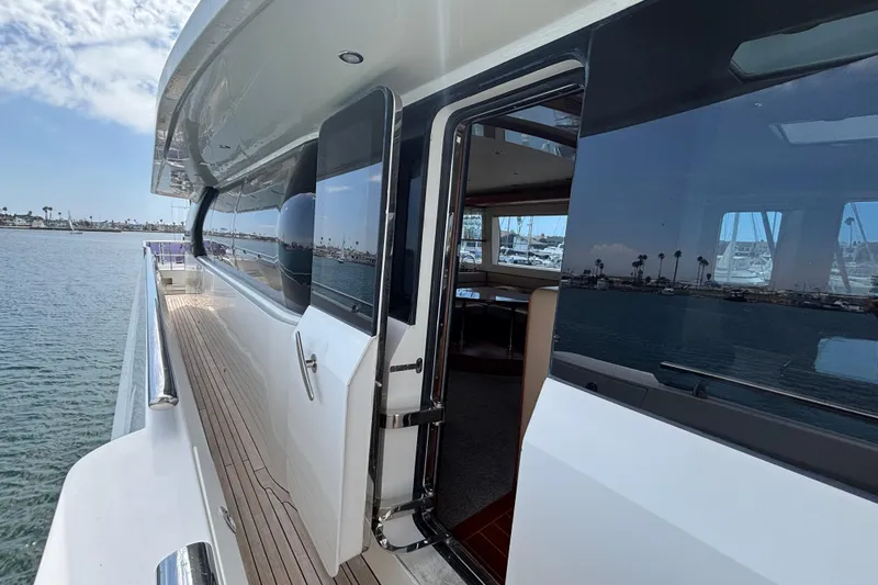 Slide: The Image of Norseman 80 yacht, 2010 model, featuring sleek exterior and open cabin door by the water. - 153