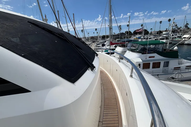 Slide: The Image of 2010 Norseman 80 yacht docked in marina, surrounded by sailboats under blue sky. - 156