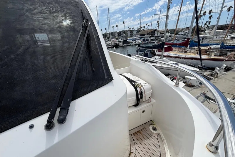 Slide: The Image of 2010 Norseman 80 yacht docked at marina with lifeboat and clear sky. - 158