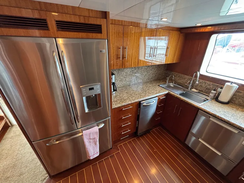Slide: The Image of Luxurious yacht kitchen with stainless steel appliances, granite countertops, and wood cabinetry, Norseman 80, 2010. - 16