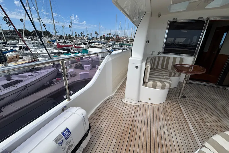 Slide: The Image of Luxurious 2010 Norseman 80 yacht deck with seating, docked at a marina. - 163