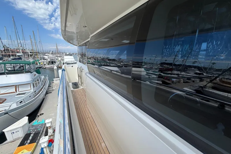 Slide: The Image of Norseman 80 yacht docked at marina, reflecting boats and clear sky, 2010 model. - 165