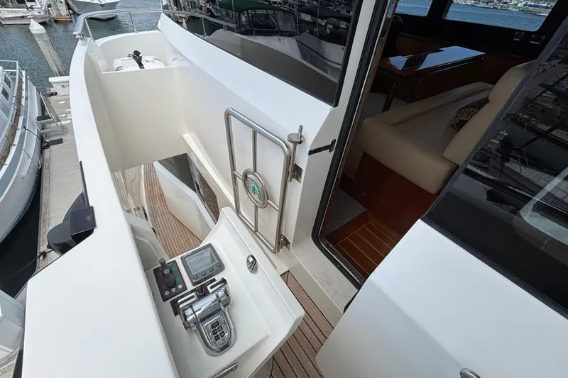 Slide: The Image of 2010 Norseman 80 yacht deck with control panel and open cabin door. - 167