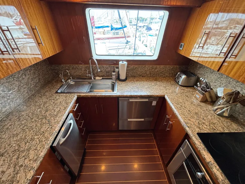 Slide: The Image of Luxurious yacht kitchen with granite countertops, stainless steel appliances, and wooden cabinetry. Norseman 80, 2010. - 17