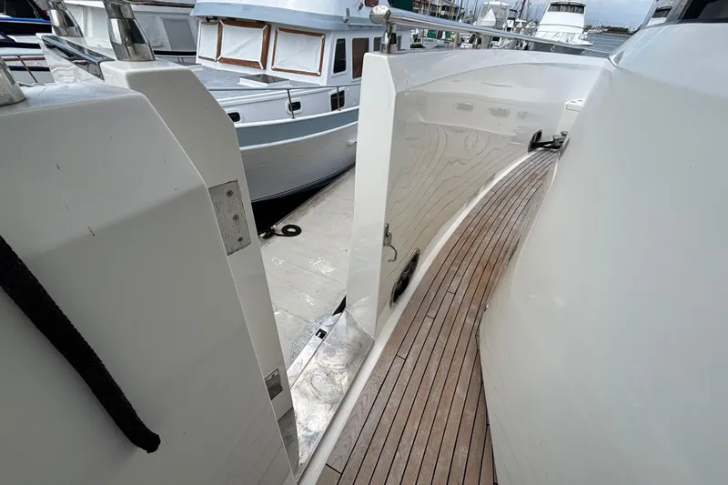 Slide: The Image of Norseman 80 yacht deck, 2010 model, docked alongside other boats. - 173