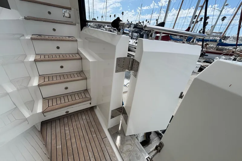 Slide: The Image of Staircase and open door on a 2010 Norseman 80 yacht, docked at a marina. - 174